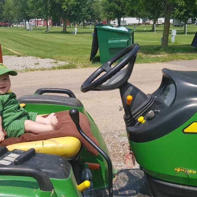 Youngest camper, Jesse Jeffrey, hard at work on John Deer Tractor